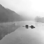 Fishing boat in foggy river